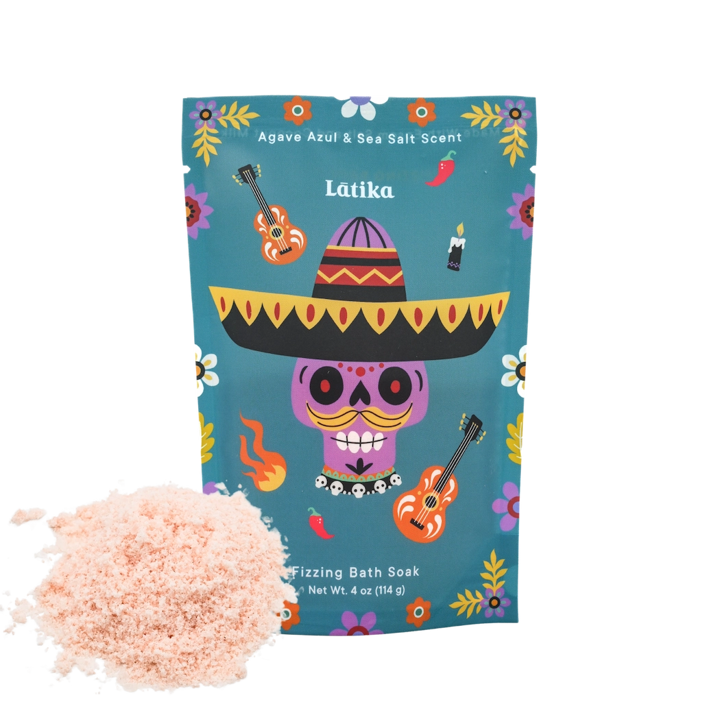 Latika bath soak packaging with a colorful design and pink bath salts on a white background. for a day of the dead theme