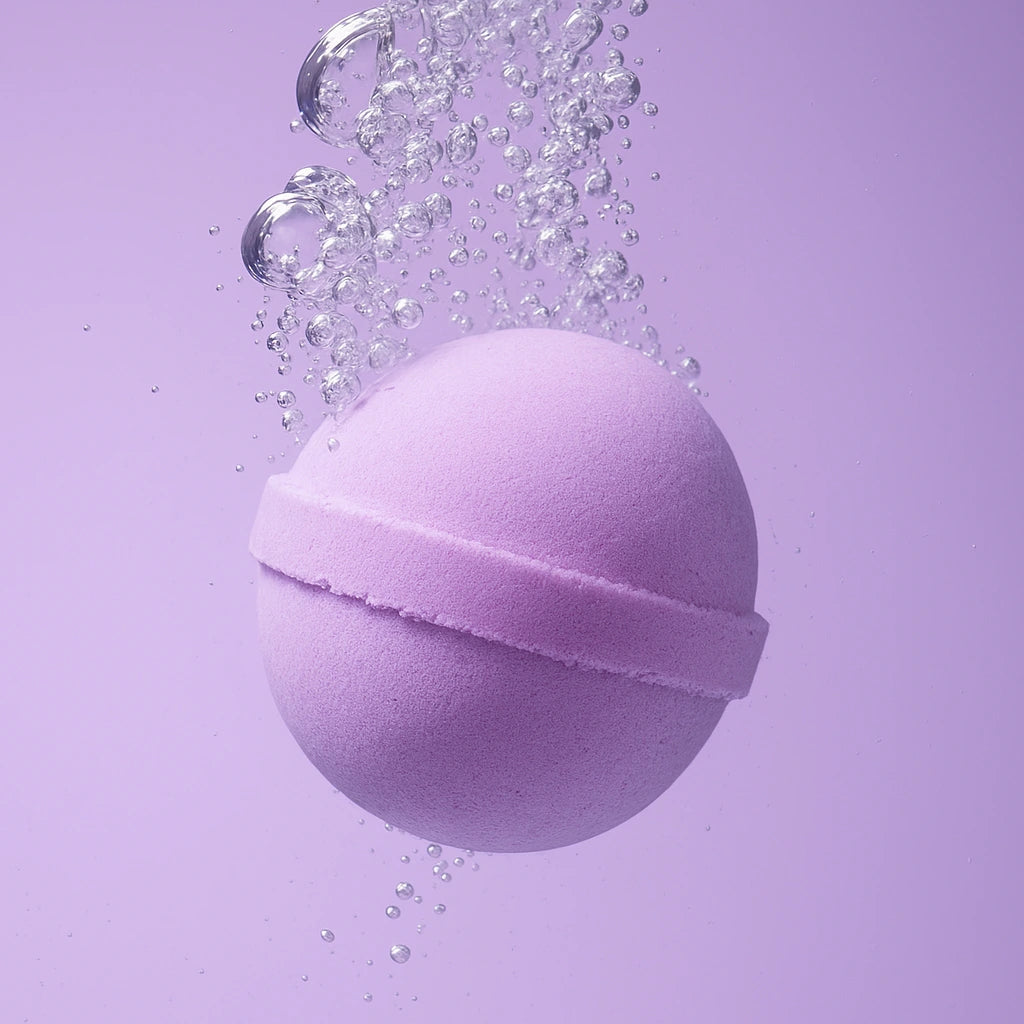 purple bath bomb in water and bubbles
