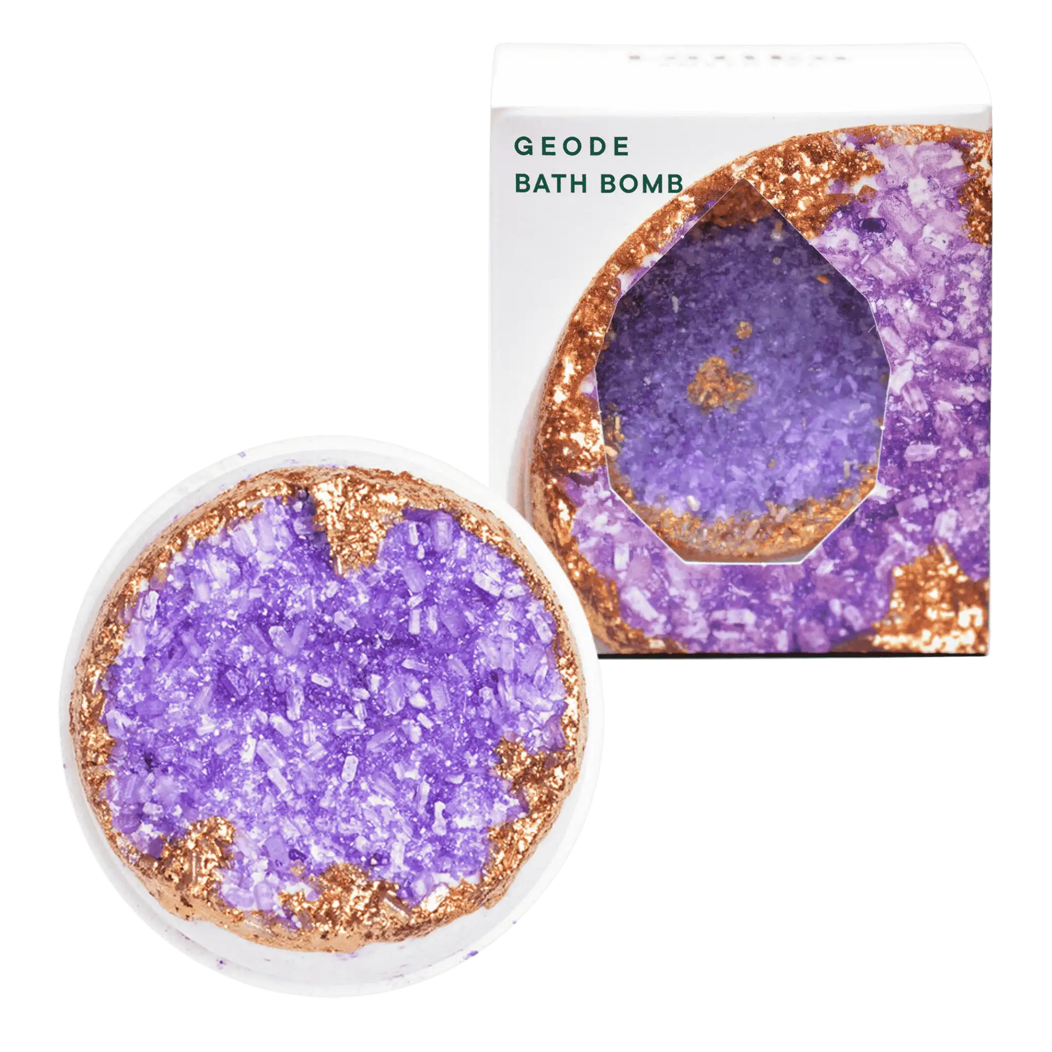 Amethyst bath bomb designed to resemble a crystal geode, with a purple center, placed next to its packaging, which has &