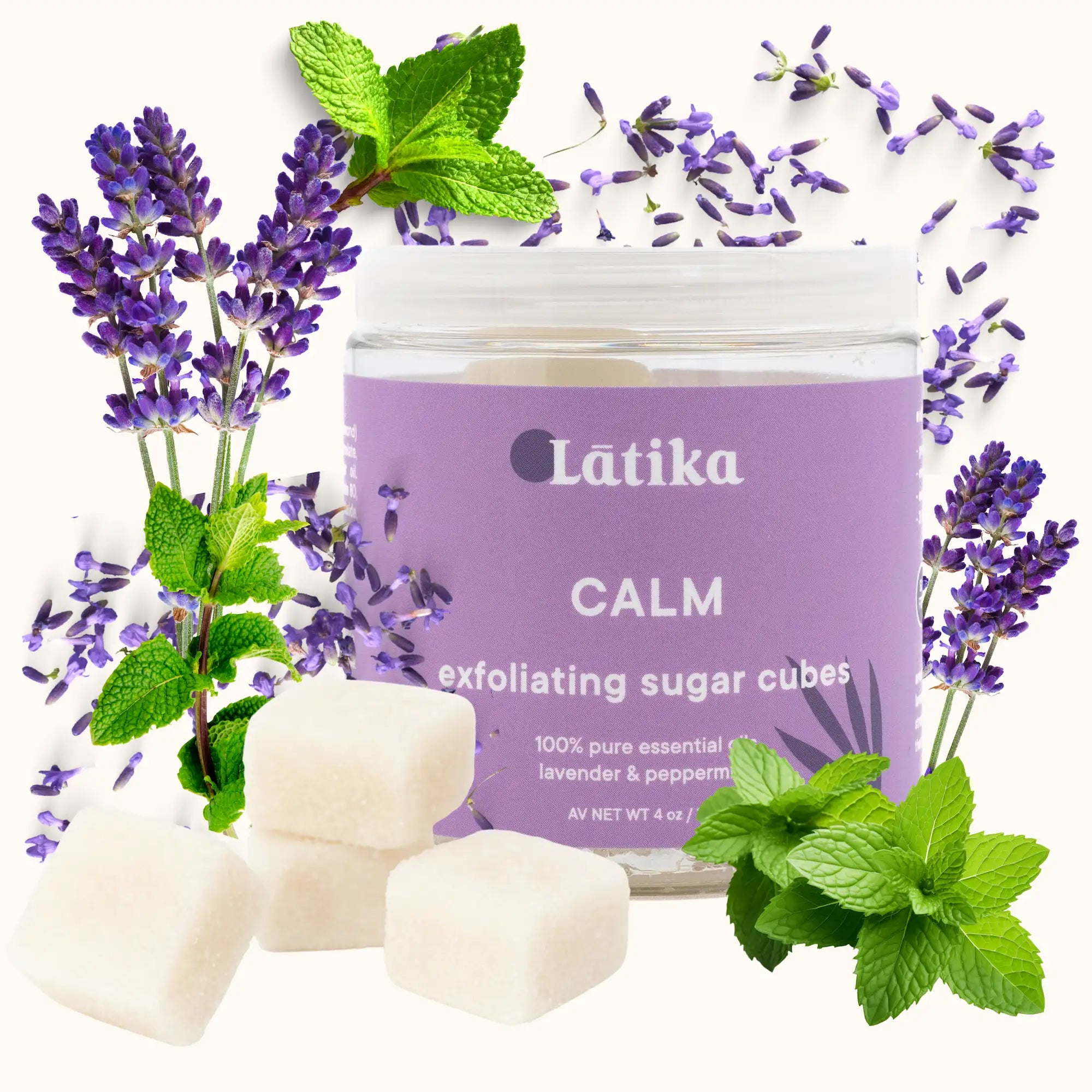 Exfoliating sugar cubes with lavender and peppermint leaves on a white background, featuring the brand &