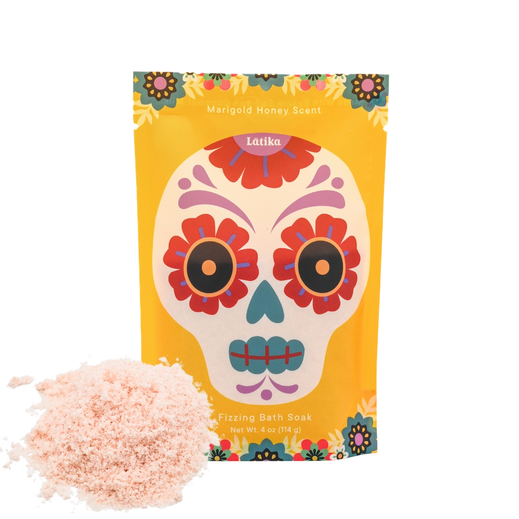 Colorful packaging of bath soak with a sugar skull design on a white background