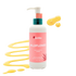 A pump bottle of Latika Wildflower Hand and Body Wash with a floral design on the label, alongside a splash of water and geranium leaves.