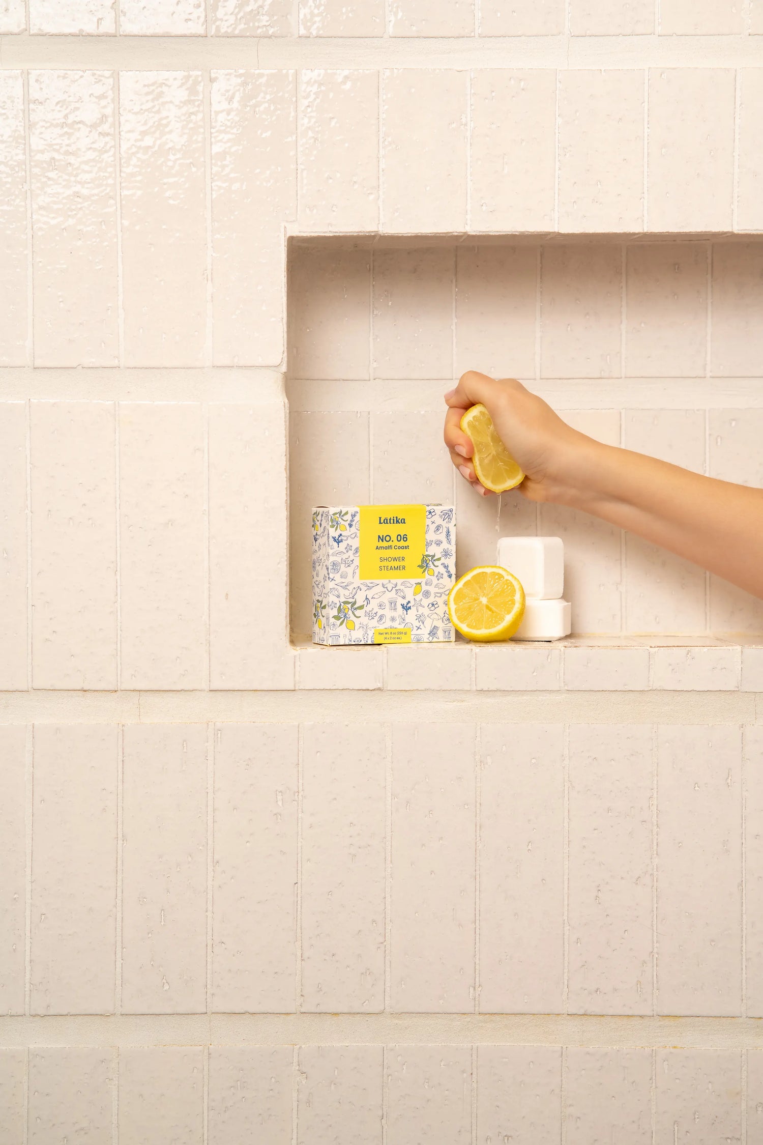 Hand holding a yellow bottle with a white container labeled &