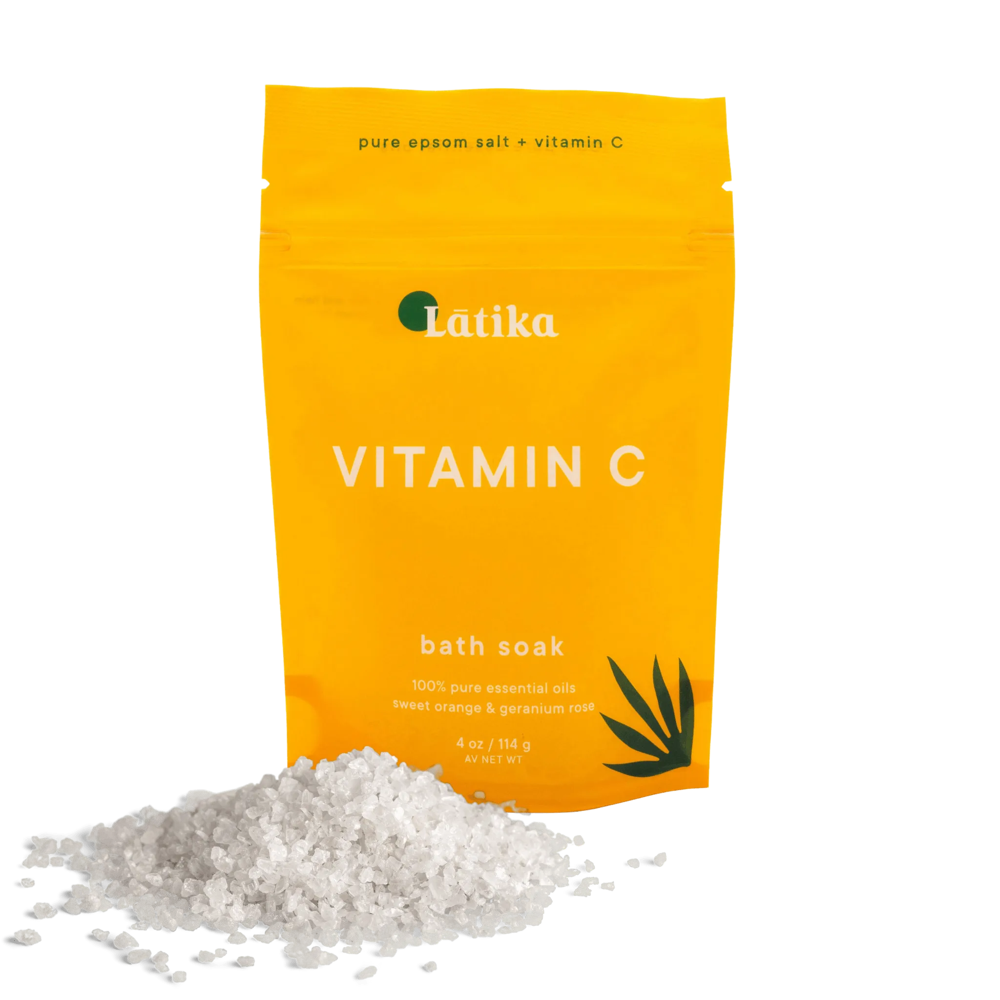 A package of Latika Vitamin C bath soak with a small pile of white Epsom salt in front of it, against a yellow background.