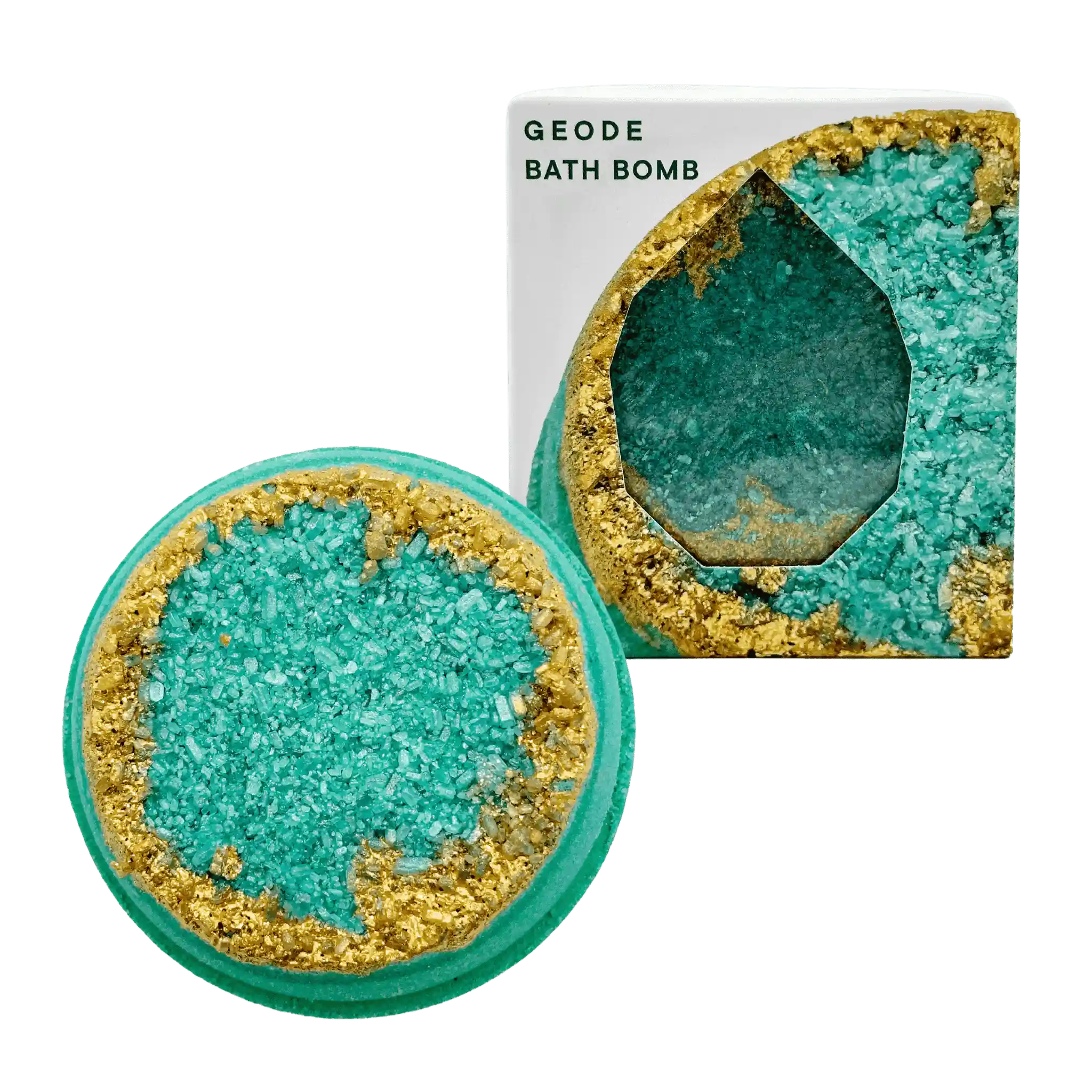A bath bomb with a geode design, featuring a emerald green center and gold accents, alongside its packaging.