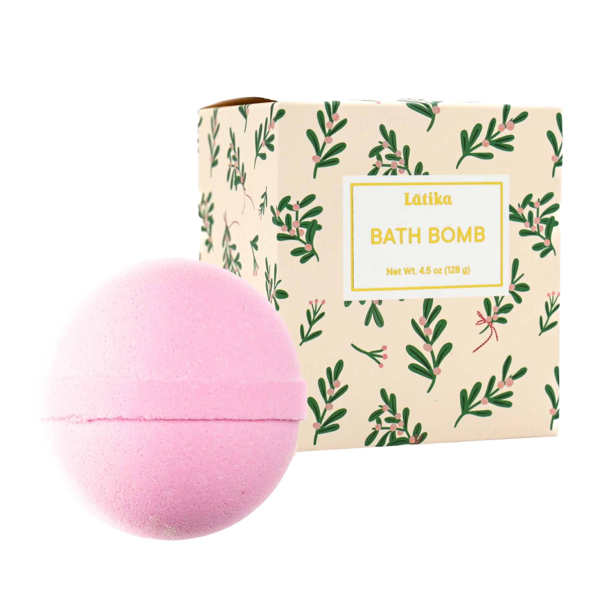 Pink bath bomb next to its packaging with green leaf pattern on a white background