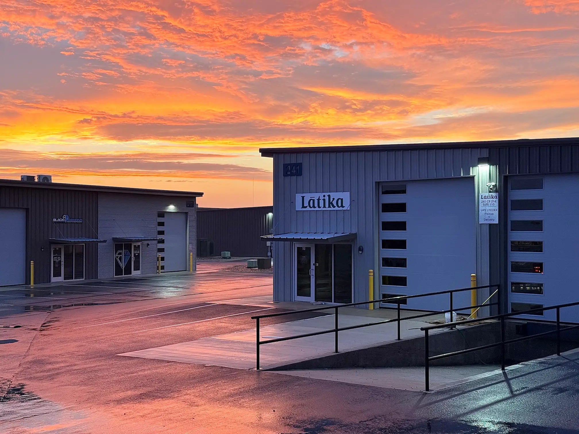 Factory building with 'Latika' sign at sunset