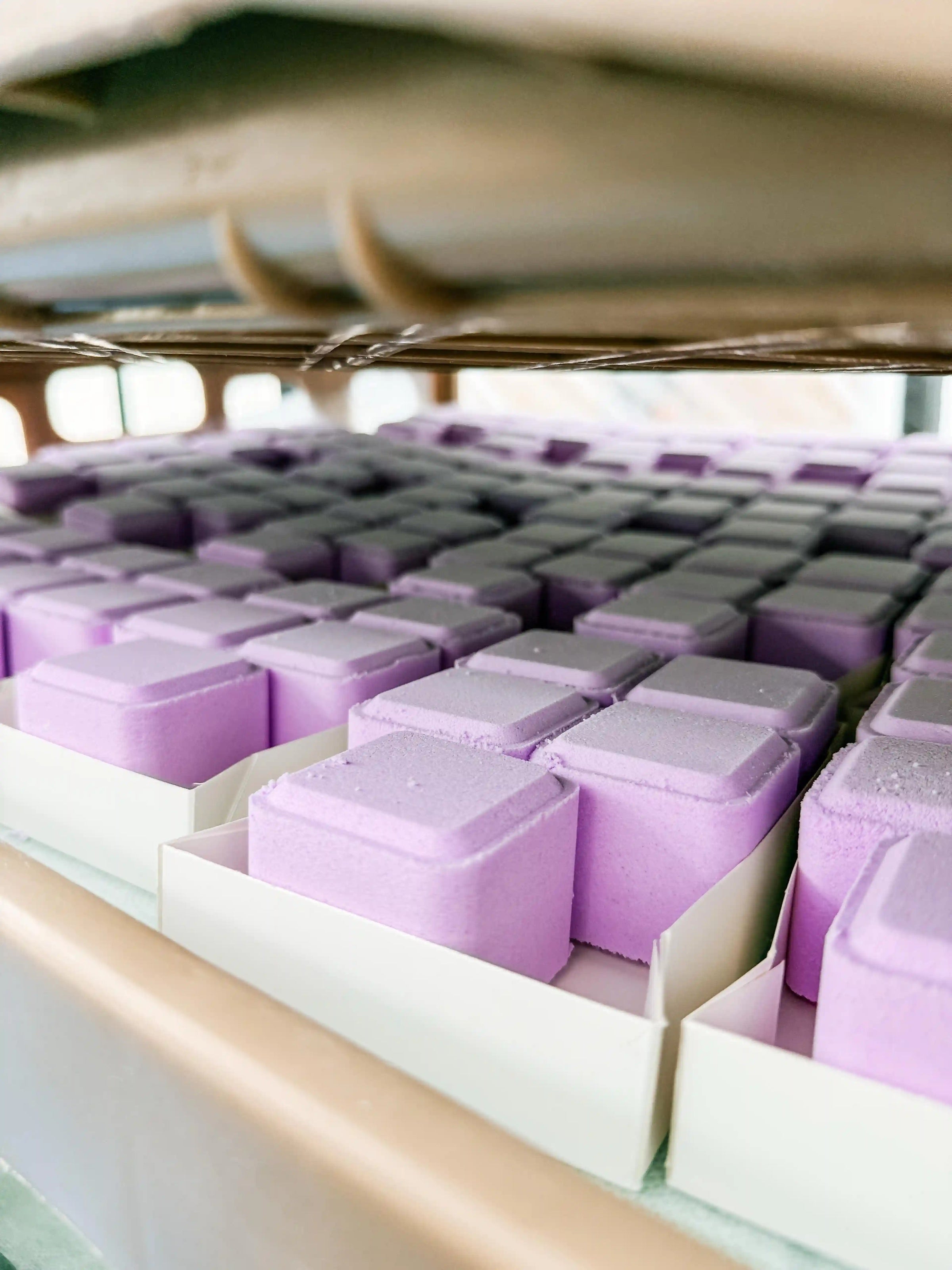 Close-up of purple soap bars in a display case
