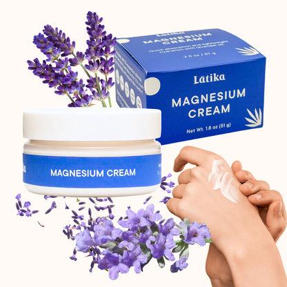 Látika magnesium cream with packaging, lavender flowers, and a hand applying the cream.