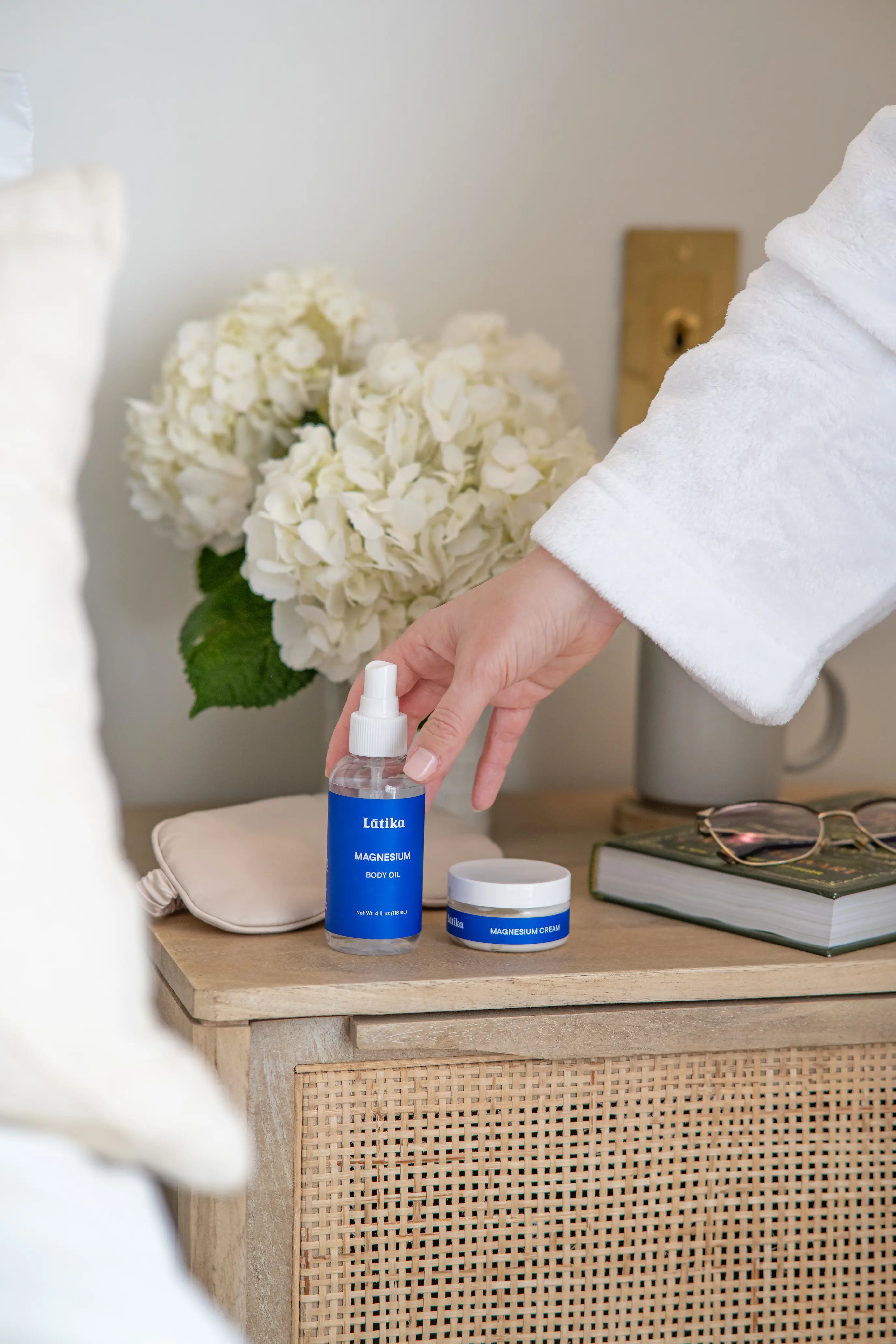 Person holding a blue magnesium oil labeled &