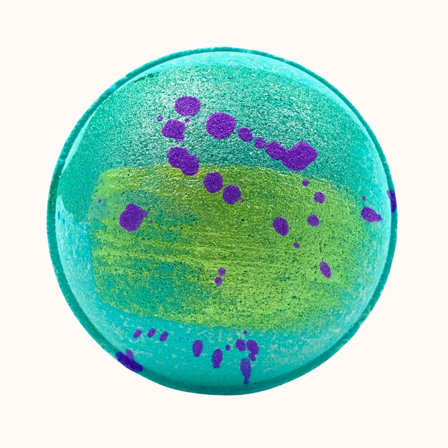 Round bath bomb with green and purple colors for a mermaid inspired bath