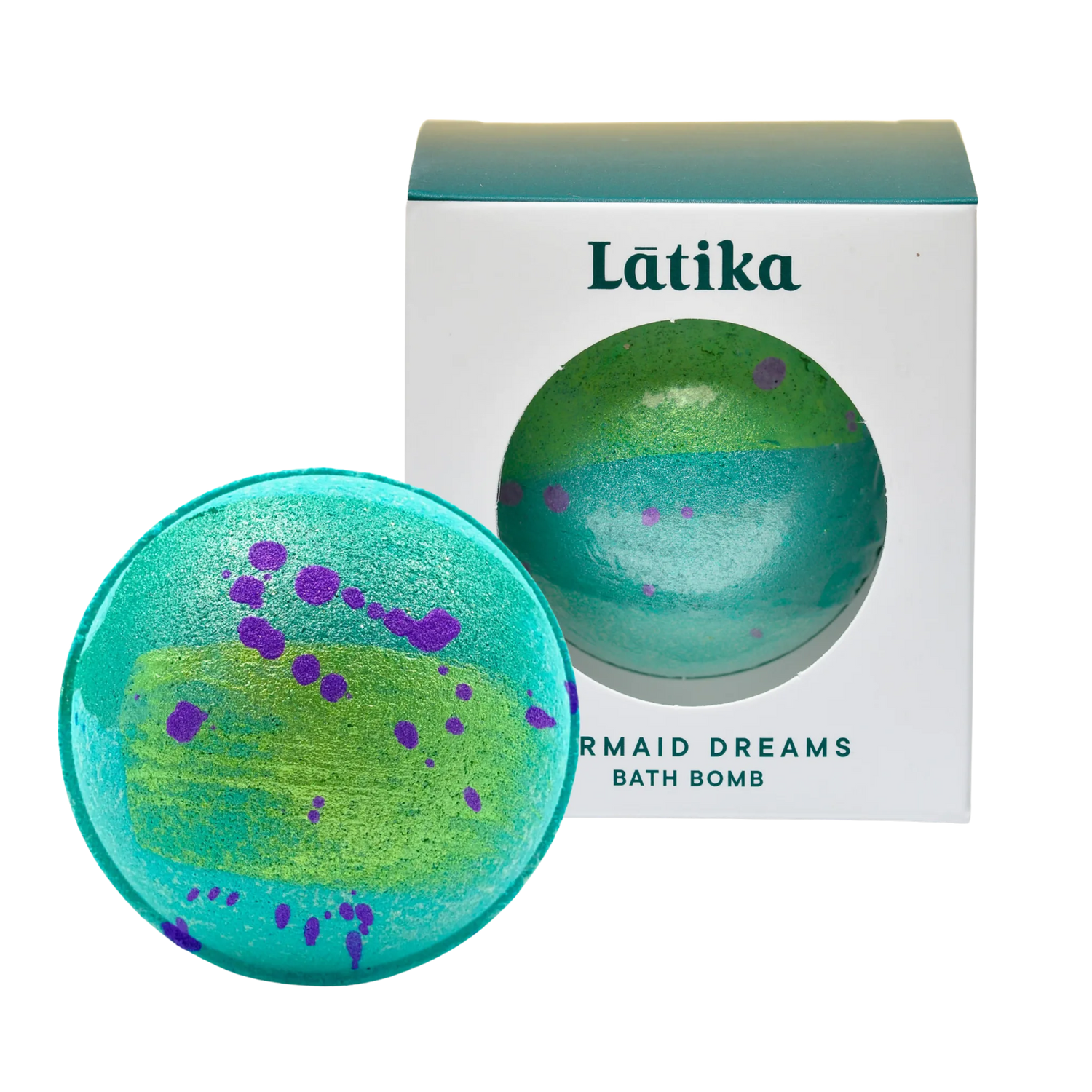 Green and purple bath bomb with packaging labeled &