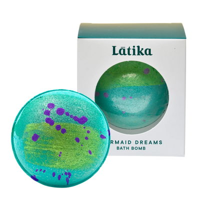 Green and purple bath bomb with packaging labeled &
