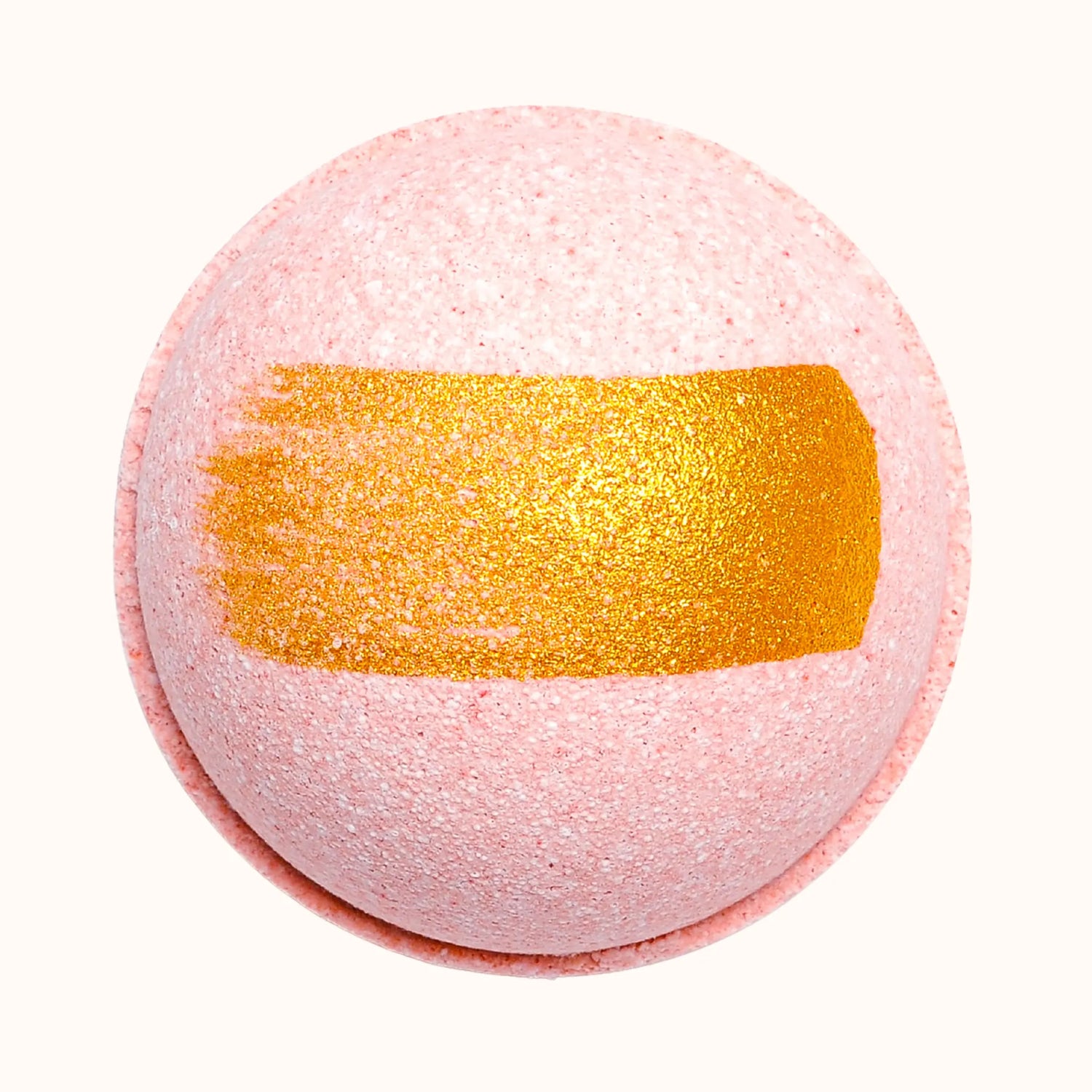 Pink bath bomb with a gold stripe on a white background