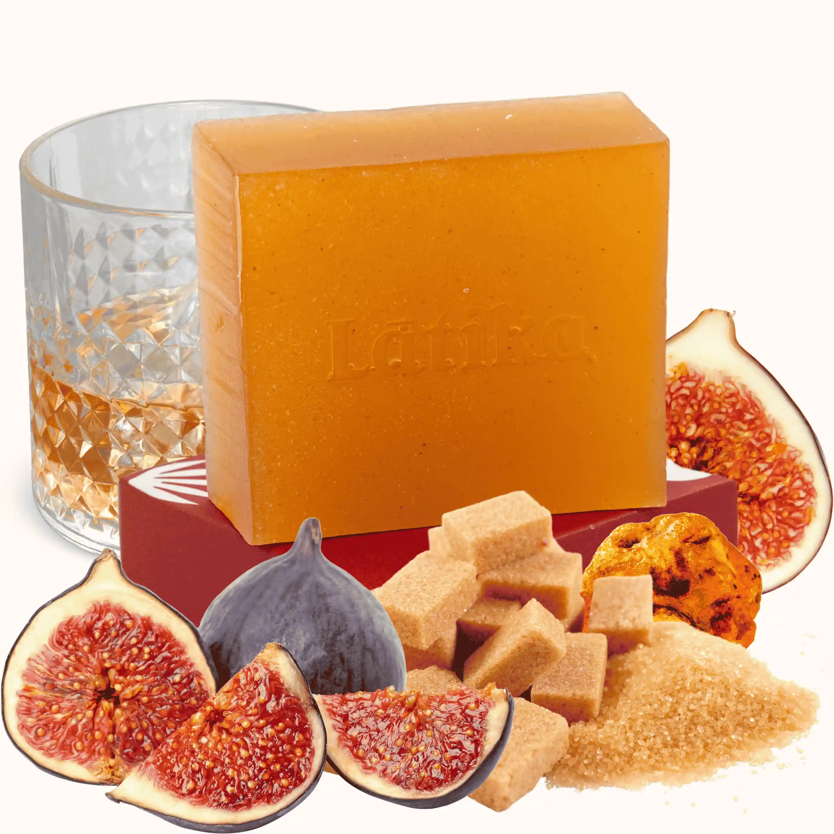 Bar of soap with figs and brown sugar on a white background