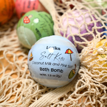 Latika Salt Kiss bath bomb with coconut milk and pink salt on a textured surface