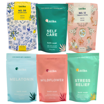 Collection of Latika bath soak packages with various scents and designs.
