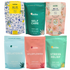Collection of Latika bath soak packages with various scents and designs.