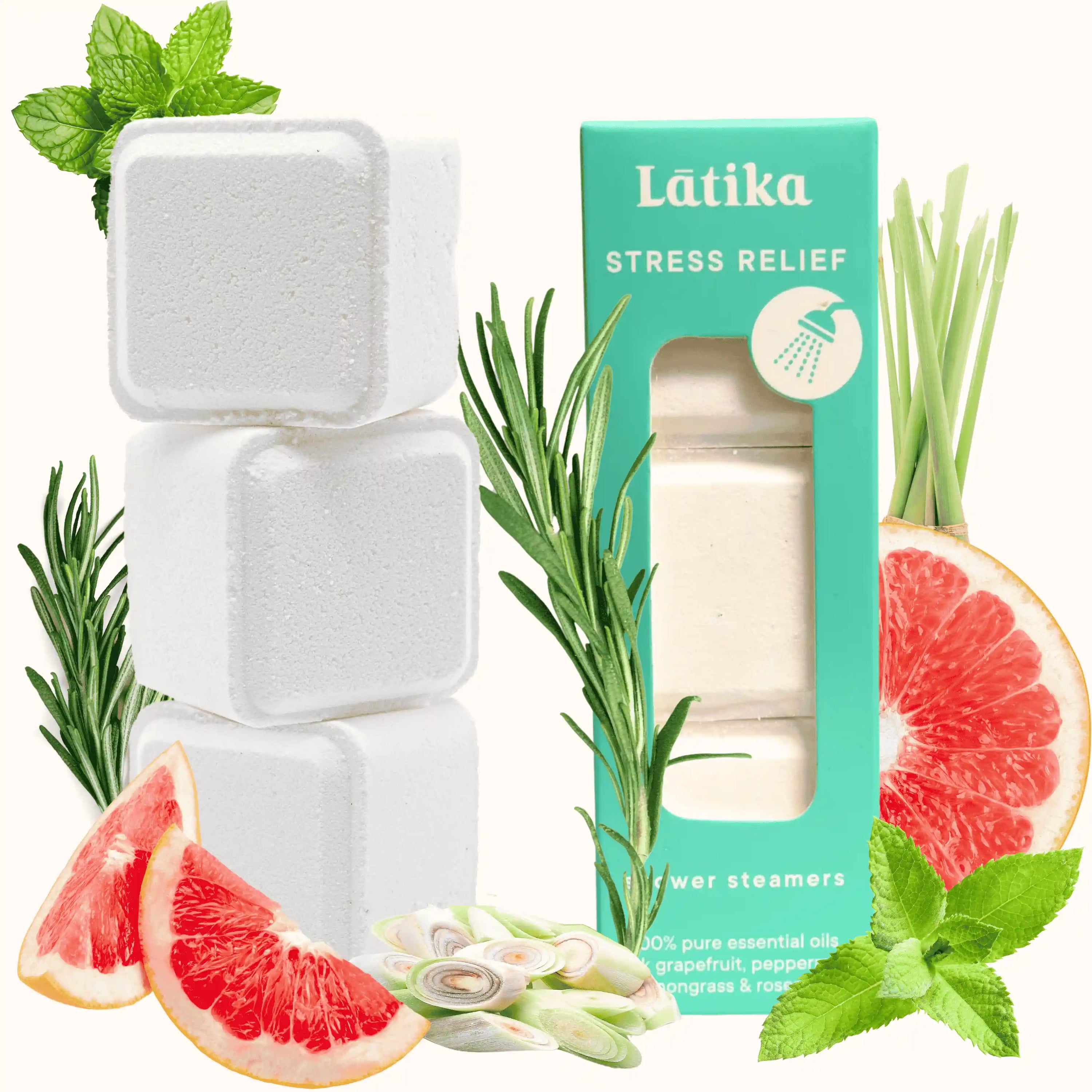 White shower cubes for stress relief surrounded by greenery and fruit slices.