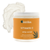 vitamin c body scrub with a wipped texture and essential oils and vitamin c. featured in a jar with orange label by Latika.