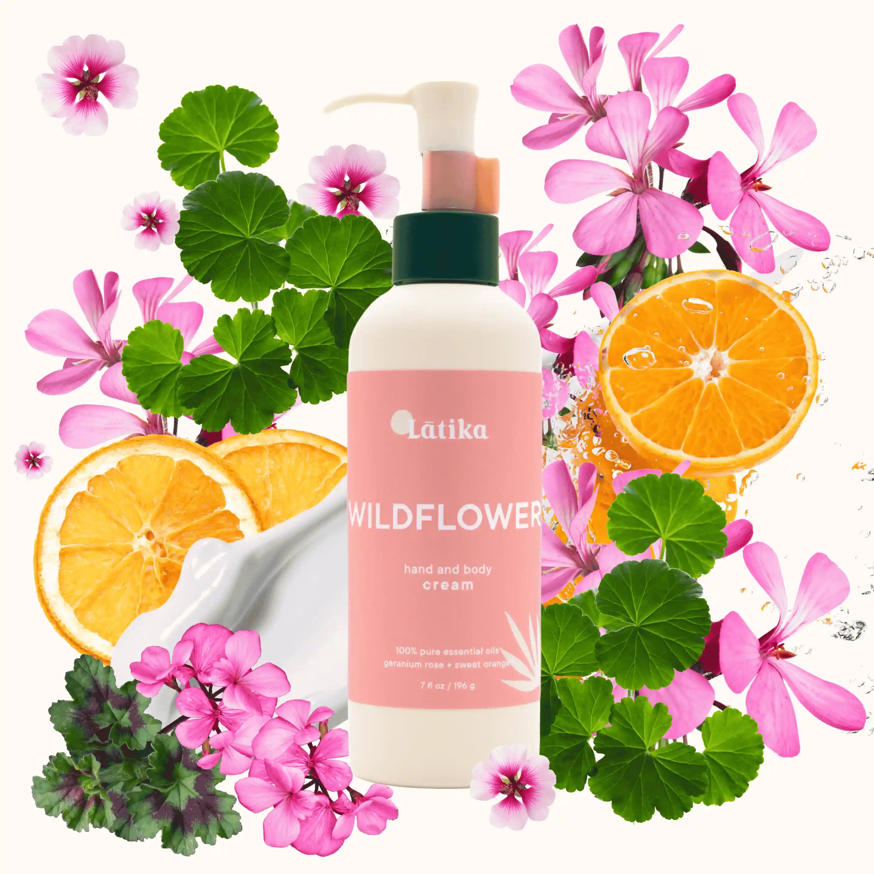 Latika Wildflowers hand and body cream bottle surrounded by flowers and oranges on a white background