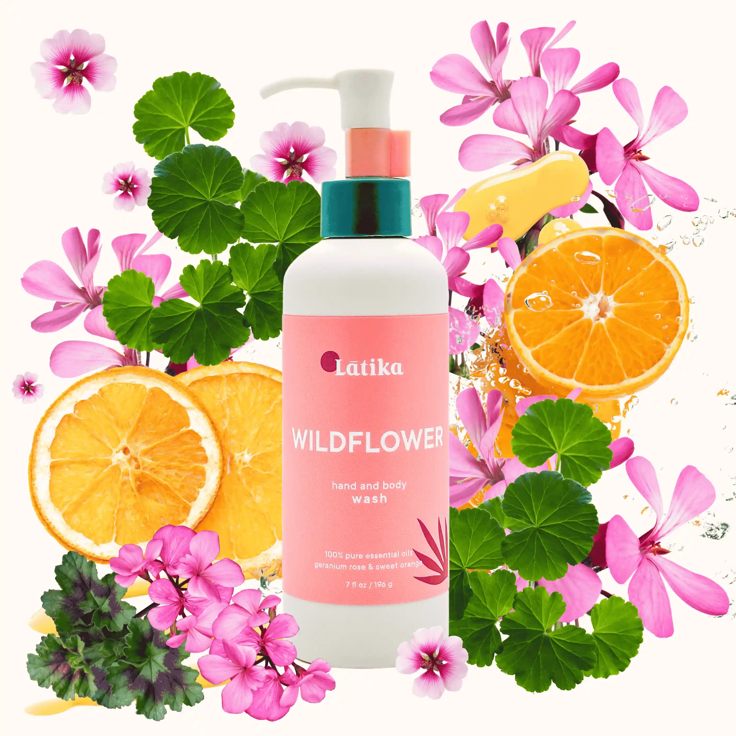 Latika Wildflower hand and body wash bottle surrounded by flowers and oranges on a white background